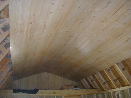 The wood paneling is slightly flexible and it can form an arch at the peak of the ceiling to eliminate a seam.