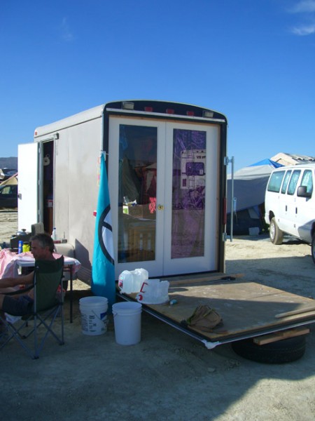 Our neighbor converted a toy hauler into a tiny shelter with French doors