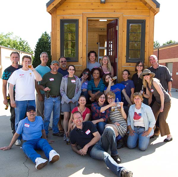 workshop crew in front of tiny house
