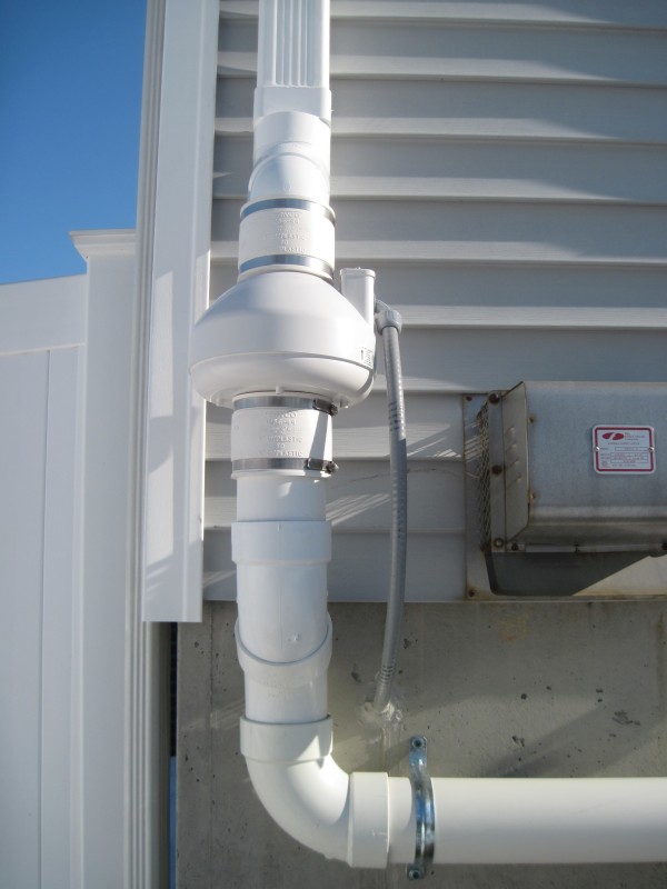 A typical exterior radon fan installation.