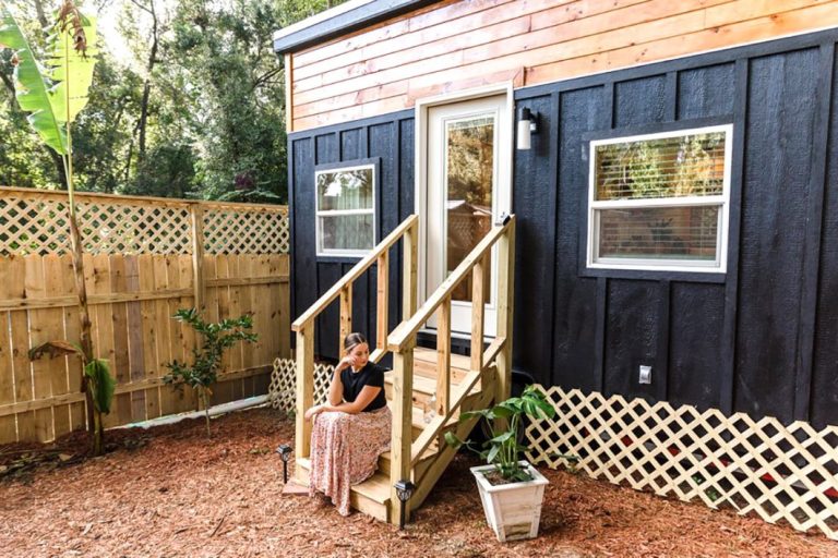 Woman in front of Tulsi tiny home