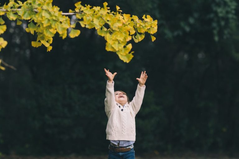 child reaching for leaves