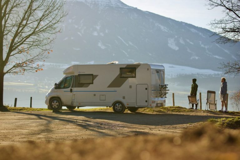 Two men and a camper by a lake